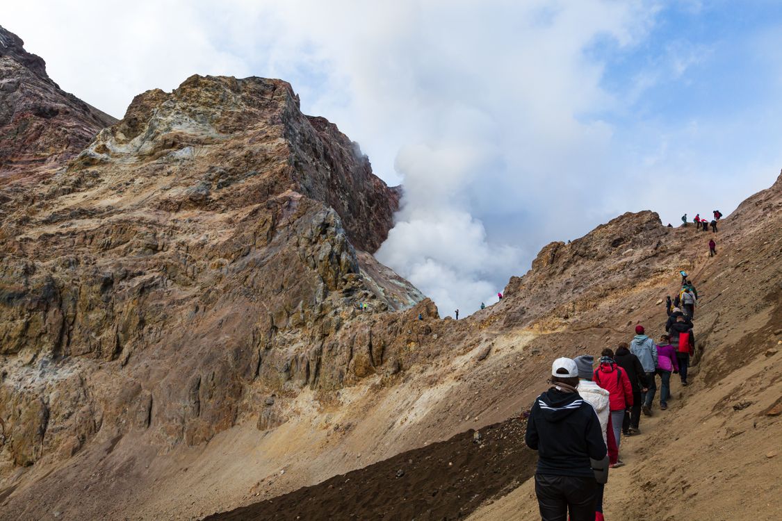 A group of hikers ascending a rocky mountain path.